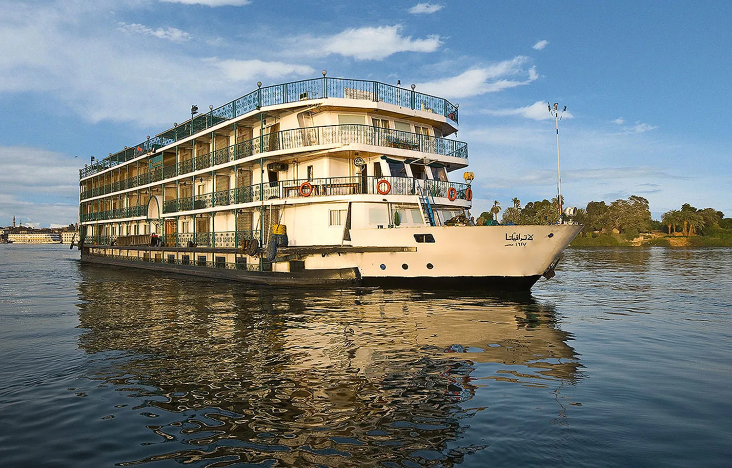 A beautiful exterior view of the multi-deck La Traviata Nile Cruise sailing on the river.