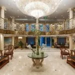 Indoor lounge area with leather seating and a view of the Nile through a window.