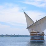 Rear view of the Loulia Dahabiya sailing on the Nile under a blue sky.