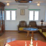 An indoor lounge area with traditional Egyptian wooden furniture and yellow cushions.