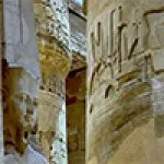 Ancient Egyptian columns and statues with hieroglyphs.