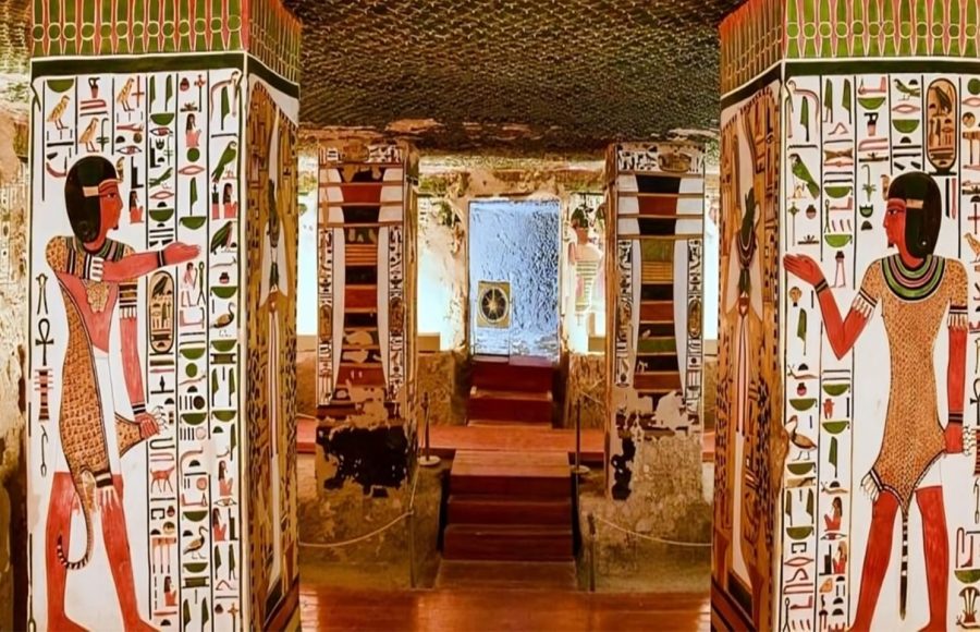 Interior view of an ancient Egyptian tomb with painted pillars and walls