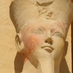 Close-up of a statue head of Queen Hatshepsut with faint color remnants