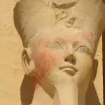 Close-up of a statue head of Queen Hatshepsut with faint color remnants