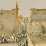 Sepia-toned image of the entrance and pylon of an Egyptian temple with an obelisk