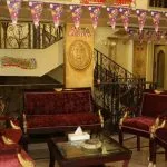 Ship lobby with red velvet chairs and holiday decorations.