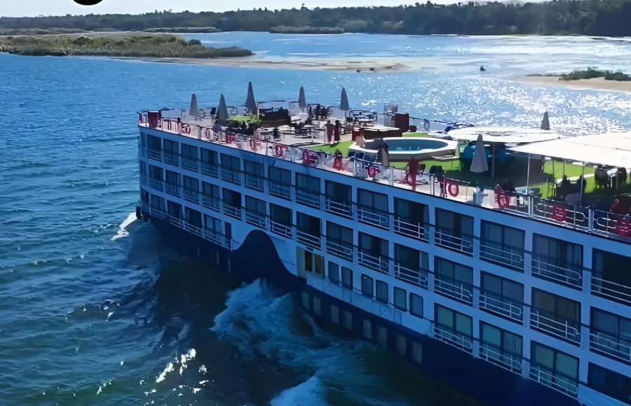 High-angle view of the MS Al Nabilatan cruise ship showing the full sun deck layout and the Nile River.
