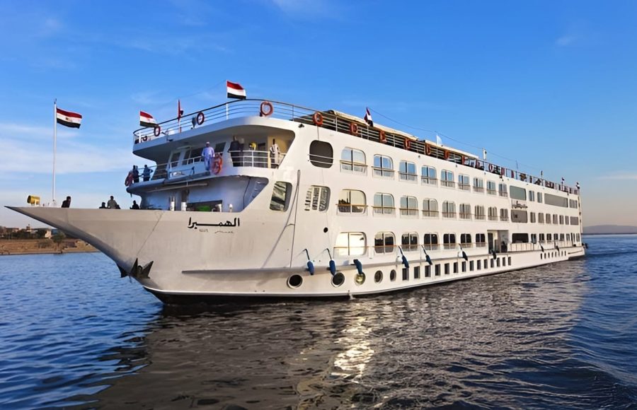 Large white MS Al Hambra cruise ship sailing on the Nile River under a clear blue sky.
