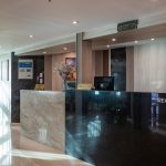 The elegant reception desk on the MS Chateau Lafayette Nile Cruise, featuring polished black marble, contemporary wood finishes, and a welcoming guest lobby setup.