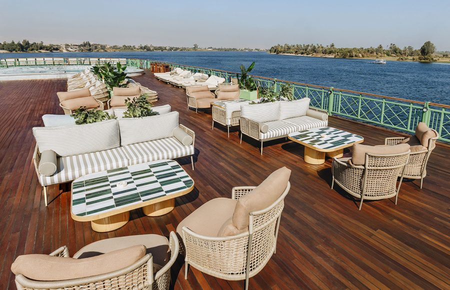 Comfortable outdoor seating and sofas on the Sun Deck of the MS Esmeralda Nile Cruise, overlooking the scenic Nile River.