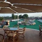 Nile cruise ship named "Monaco" sailing on the river.