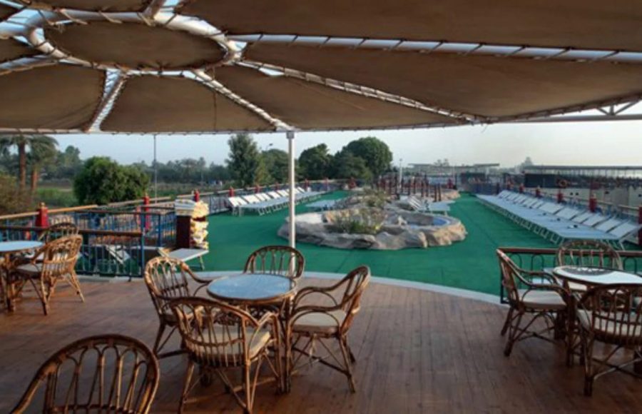 Nile cruise ship named "Monaco" sailing on the river.