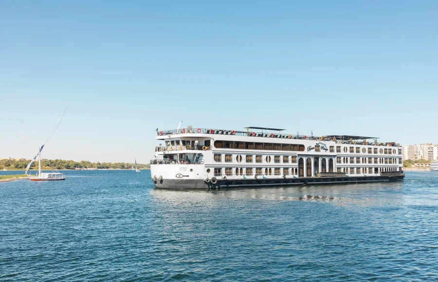 A cruise ship sailing the Nile River from Luxor to Aswan, a key part of the Egypt 12 Day Tour.