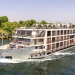 Four-deck MS Dolphin Nile cruise ship sailing on the Nile River.