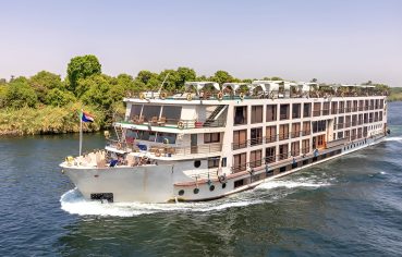 Four-deck MS Dolphin Nile cruise ship sailing on the Nile River.