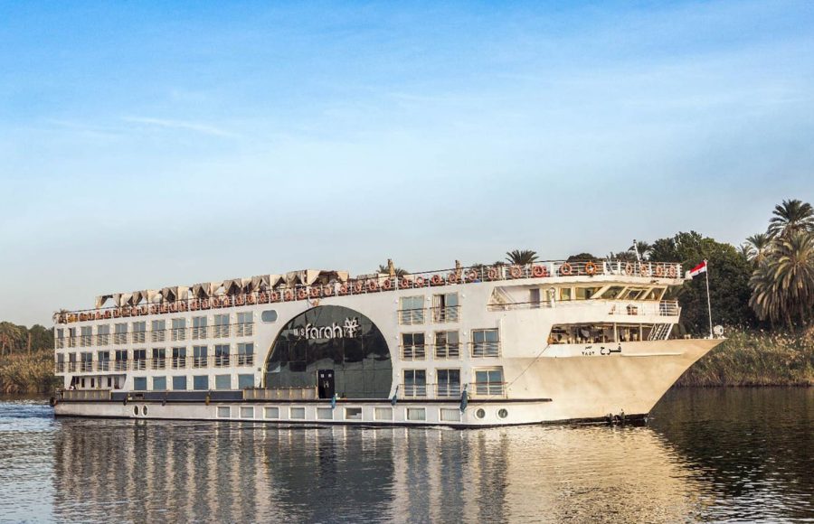 MS Farah Nile cruise ship sailing on the river under a clear blue sky.