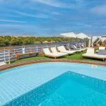 MS Farah Nile cruise ship sailing on the river, showing its distinct central arched window.