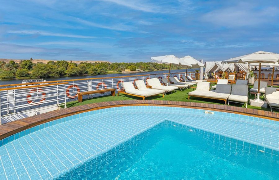 MS Farah Nile cruise ship sailing on the river, showing its distinct central arched window.