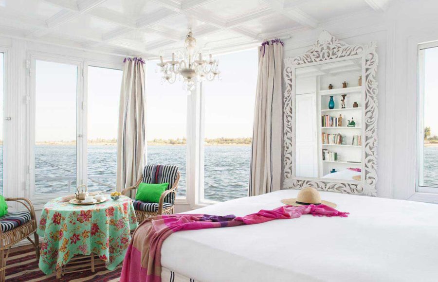 Luxury suite interior with a turquoise floral table setting and panoramic river views.