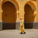 Man-walking-in-the-mausoleum-of-moulay-ismail-in-meknes-morocco