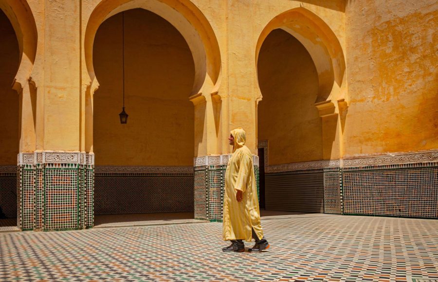 Man-walking-in-the-mausoleum-of-moulay-ismail-in-meknes-morocco