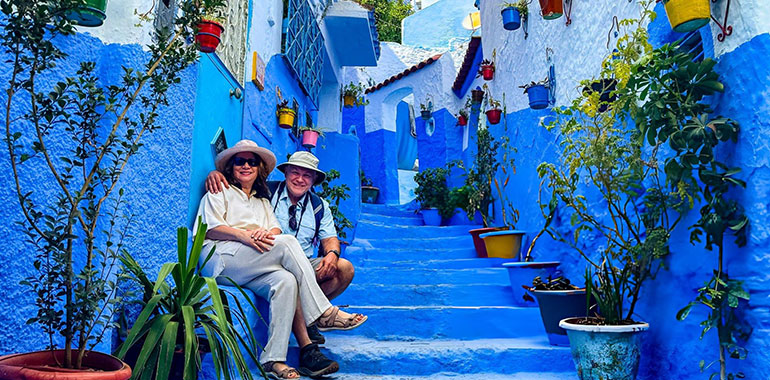 Mature couple posing on stairway in Chefchaouen