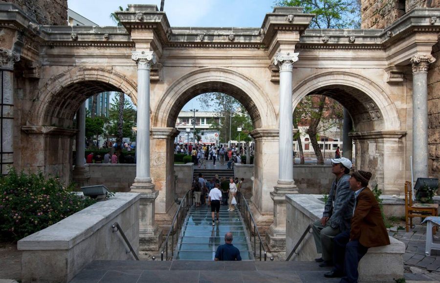 Men-sit-at-the-stairs-which-lead-through-The-Gate-of-Hadrian-built-in-honour-of-the-Roman-emperor-Hadrian-in-Kaleici-at-Antalya-in-Turkey