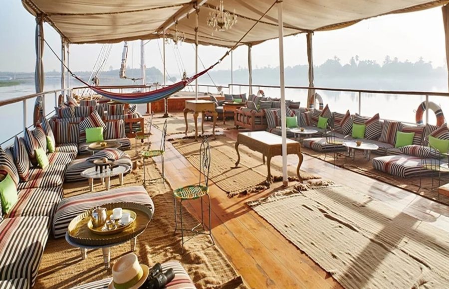 Sundeck of the Meroe Dahabiya Nile boat with lounge areas and a hammock.
