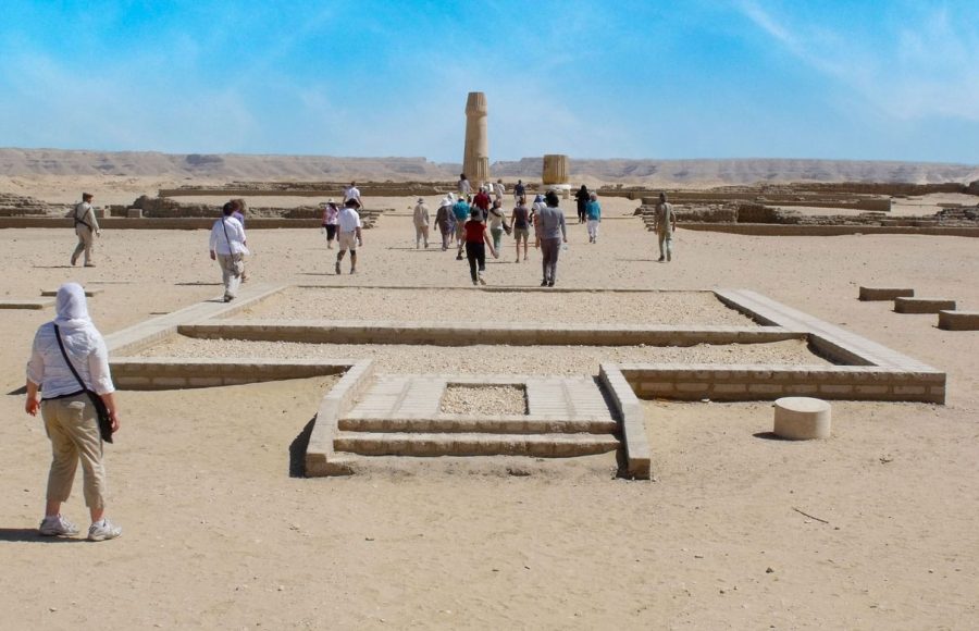 A group explores the desert ruins of Tell Amarna, an important stop on a Beni Hassan tour itinerary through ancient Egypt