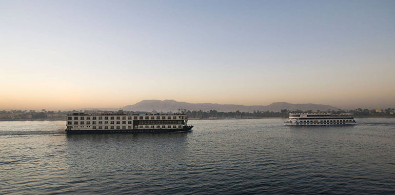 Modern Luxury Cruise Boats Passing On The River Nile At Sunset Luxor Egypt North Africa