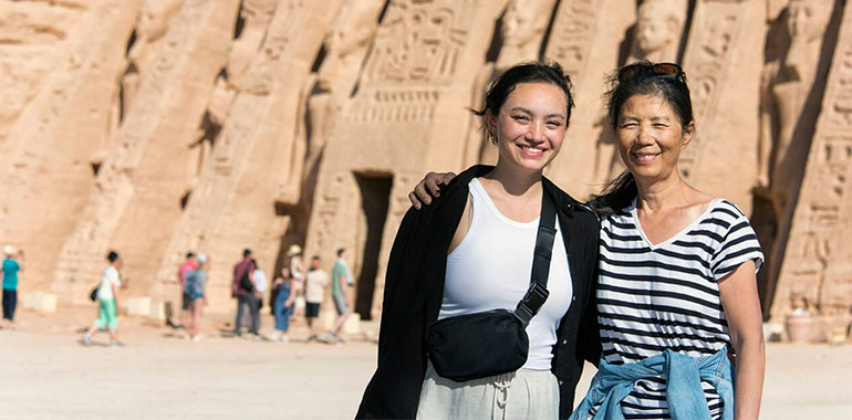 Mother And Daughter Tourists Standing In Front Of The Temple Of Hathor At Abu Simbel Aswan Nubia Egypt