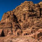 Nabataean-tombs-carved-into-the-cliff-side-in-southern-part-of-ancient-Petra-city-Jordan-Middle-East-with-blue-sky