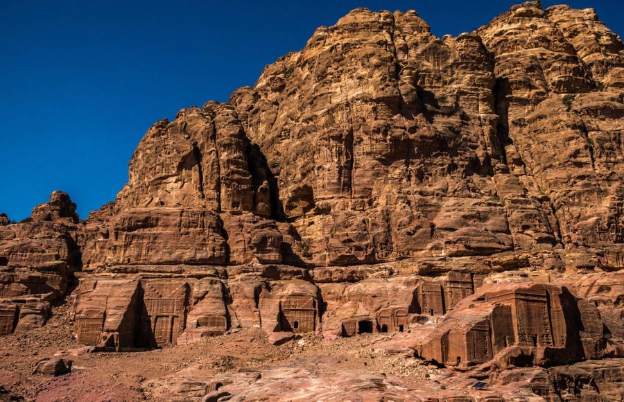 Nabataean-tombs-carved-into-the-cliff-side-in-southern-part-of-ancient-Petra-city-Jordan-Middle-East-with-blue-sky