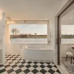 Nile cruise twin cabin with window seat and sunset view.