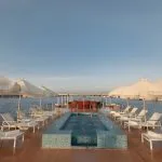 Nile cruise dahabiya sundeck with pool and lounge chairs.