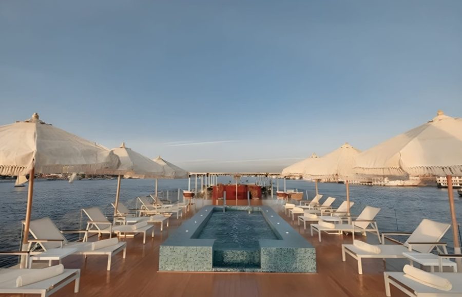 Nile cruise dahabiya sundeck with pool and lounge chairs.