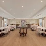 Elegant Nile cruise dining room with light pink chairs and panoramic windows.