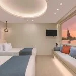Nile cruise twin cabin with window seat and sunset view.