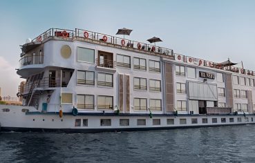 Short Alternative Text: Exterior of the white H.S. Nebu Nile Cruise ship sailing on the river.