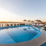 The swimming pool and loungers on the top deck of a cruise ship, offering a perfect break on your 10 day Nile and Lake Nasser holiday.