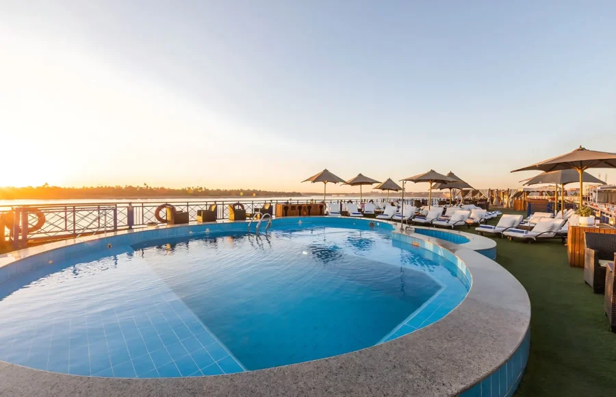 The swimming pool and loungers on the top deck of a cruise ship, offering a perfect break on your 10 day Nile and Lake Nasser holiday.