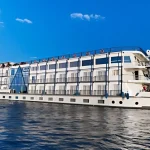 5-star Nile Cruise ship sailing the river between Aswan and Luxor, essential to the Cairo Luxor Aswan Alexandria Tour.