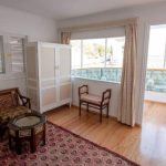 Terrace suite with seating area and balcony on a Nile cruise boat.