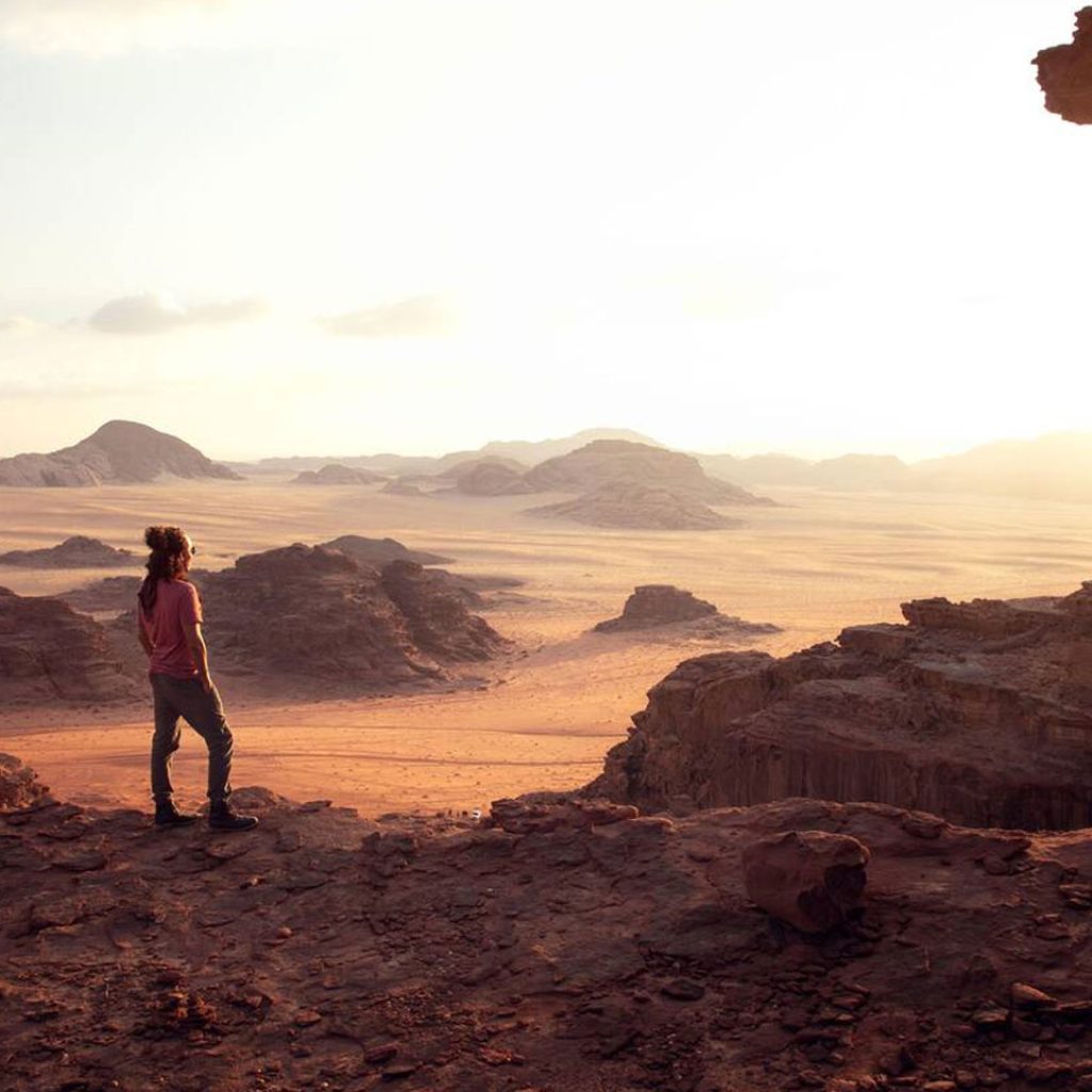 One man looking at view of desert during sunset in Wadi Rum