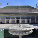 Ornate-fountain-surrounded-by-traditional-Moroccan-architecture-in-the-courtyard-of-Bahia-Palace-in-Marrakech-Morocco
