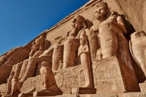 Low angle view of Abu Simbel on a Package Tour To Egypt From Delhi. A low angle shot of the massive Abu Simbel Temple facade, a grand sight on a package tour to Egypt from Delhi.