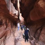 People-in-the-Khazali-canyon-famous-for-the-ancient-inscriptions-and-waterholes-Wadi-Rum-Jordan-Middle-East