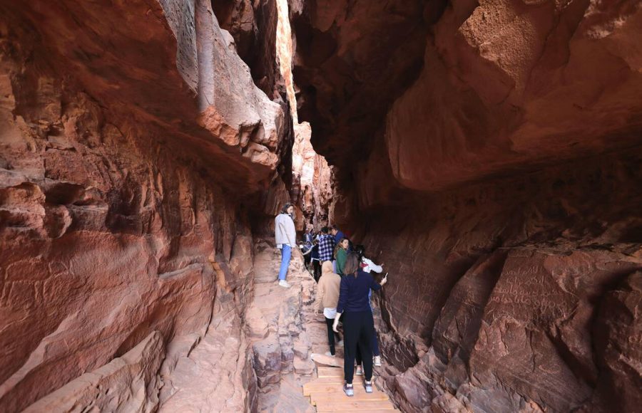 People-in-the-Khazali-canyon-famous-for-the-ancient-inscriptions-and-waterholes-Wadi-Rum-Jordan-Middle-East