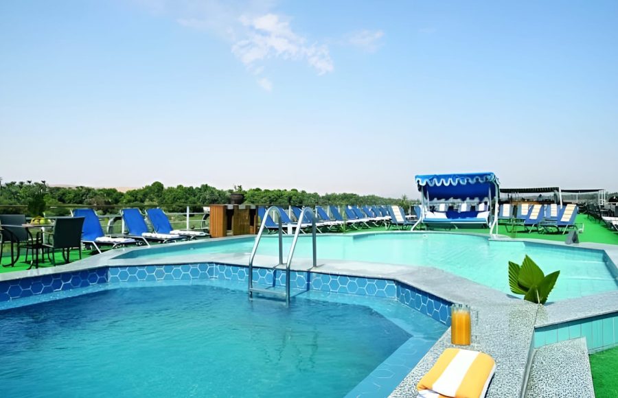 Swimming pool and sun loungers on a cruise ship's sundeck.