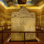 Rameses IV burial chamber sarcophagus painted with scenes from the Book of the Gates and the Amduat Valley of the Kings Egypt, with vibrant wall and ceiling paintings surrounding it, a highlight for cairo luxor sharm el sheikh tours.